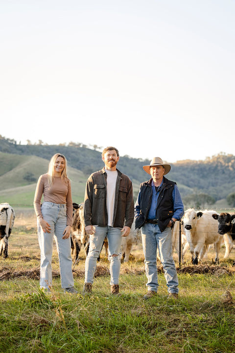 The Hunter Natural family standing in front of their cattle